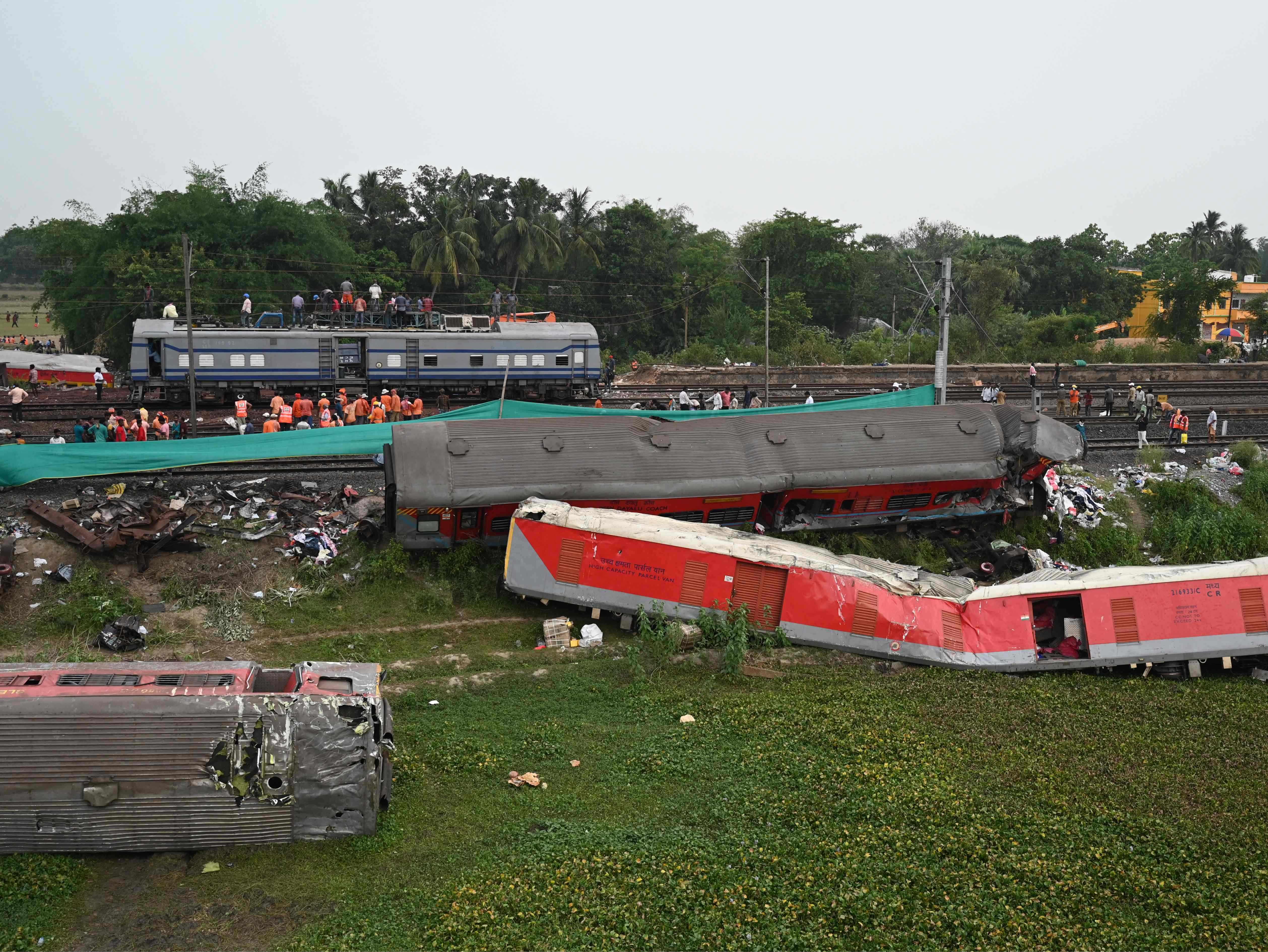 Railway workers clear the wreckage on Sunday