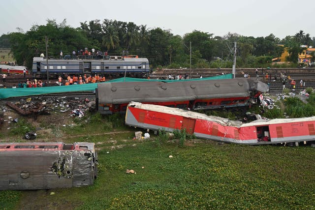 <p>Railway workers help to restore services at the accident site of a three-train collision near Balasore, about 200 km from the state capital Bhubaneswar in the eastern state of Odisha, on 4 June 2023</p>
