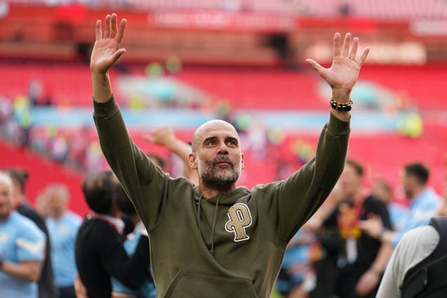 Manchester City manager Pep Guardiola celebrates winning the FA Cup at Wembley (Martin Rickett/PA)