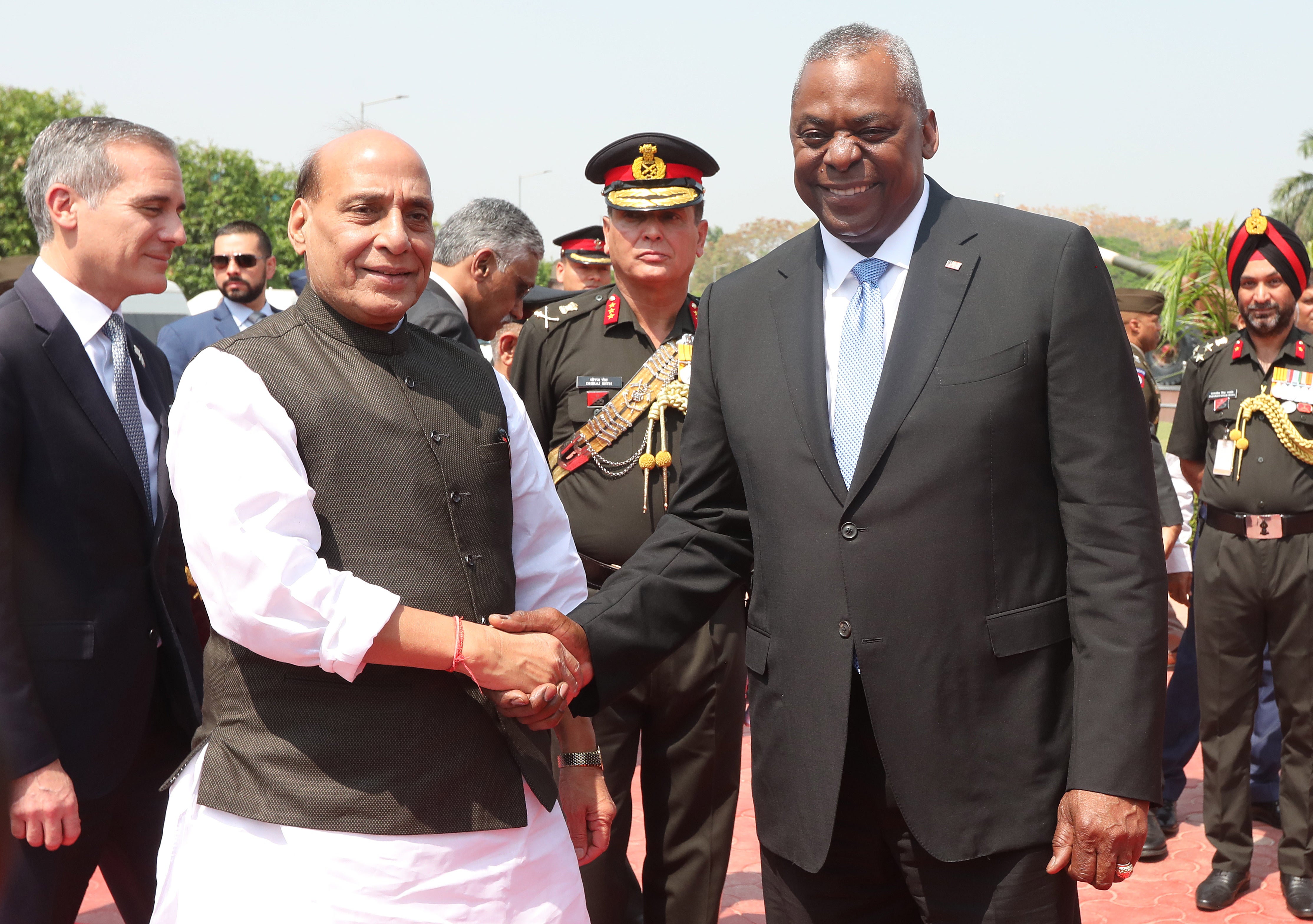 US Defence Secretary Lloyd Austin (R) shake hands with Indian Defence Minister Rajnath Singh during a ceremonial welcome ceremony