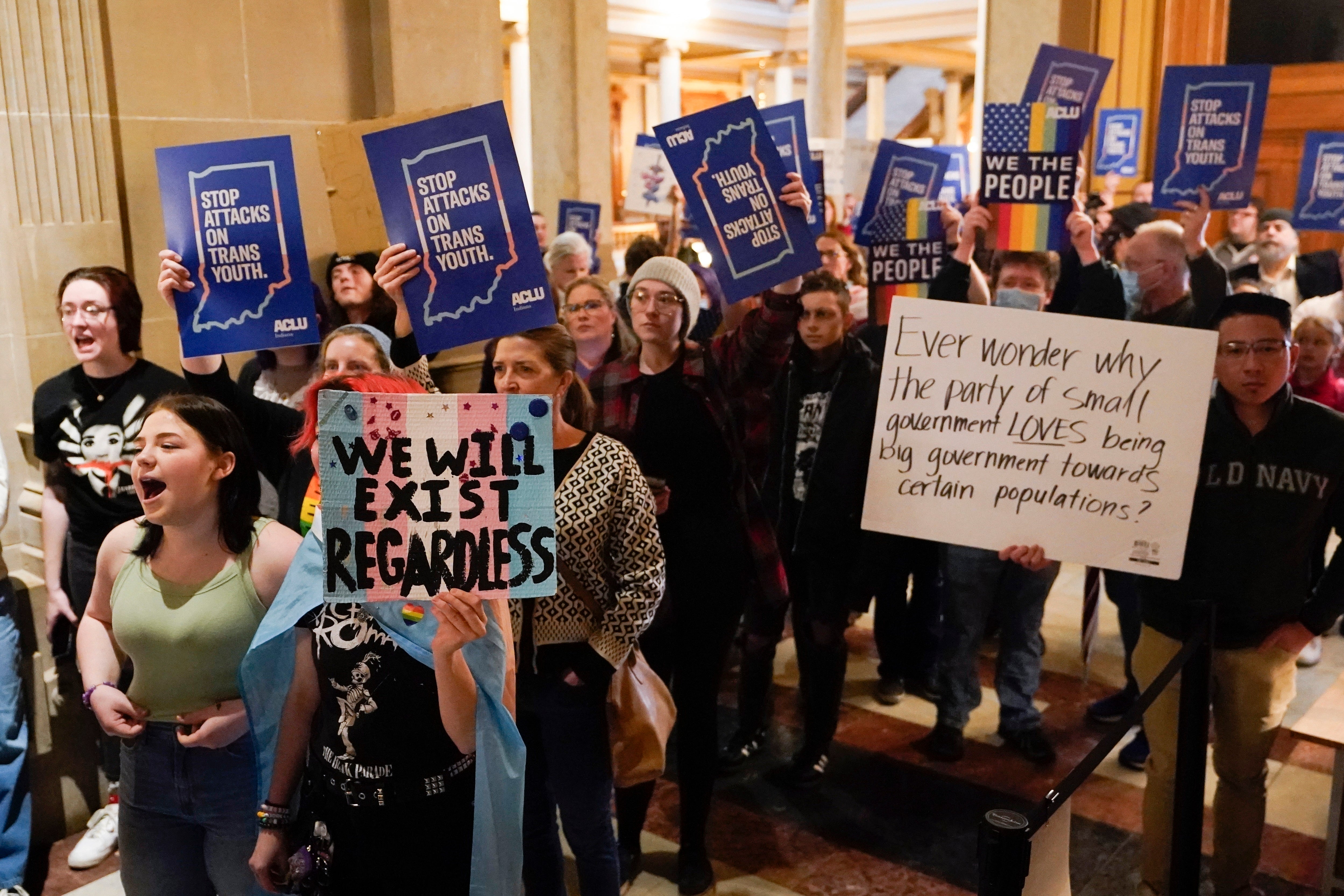 Protesters stand outside of the Senate chamber at the Indiana Statehouse on Feb. 22, 2023, in Indianapolis. The Human Rights Campaign declared a state of emergency for LGBTQ+ people in the U.S. on Tuesday, June 6 and a released a guidebook summarizing what it calls discriminatory laws in each state, along with “know your rights” information and health and safety resources. (AP Photo/Darron Cummings, File)