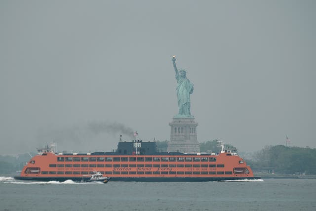 <p>The Staten Island Ferry moves past the Statue of Liberty on a hazy morning resulting from Canadian wildfires on June 06, 2023 in New York City.</p>