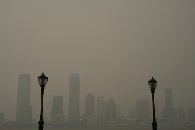 <p>Buildings in Jersey City, NJ are partially obscured by smoke from Canadian wildfires, seen from the Manhattan borough of New York on Tuesday, 6 June 2023</p>
