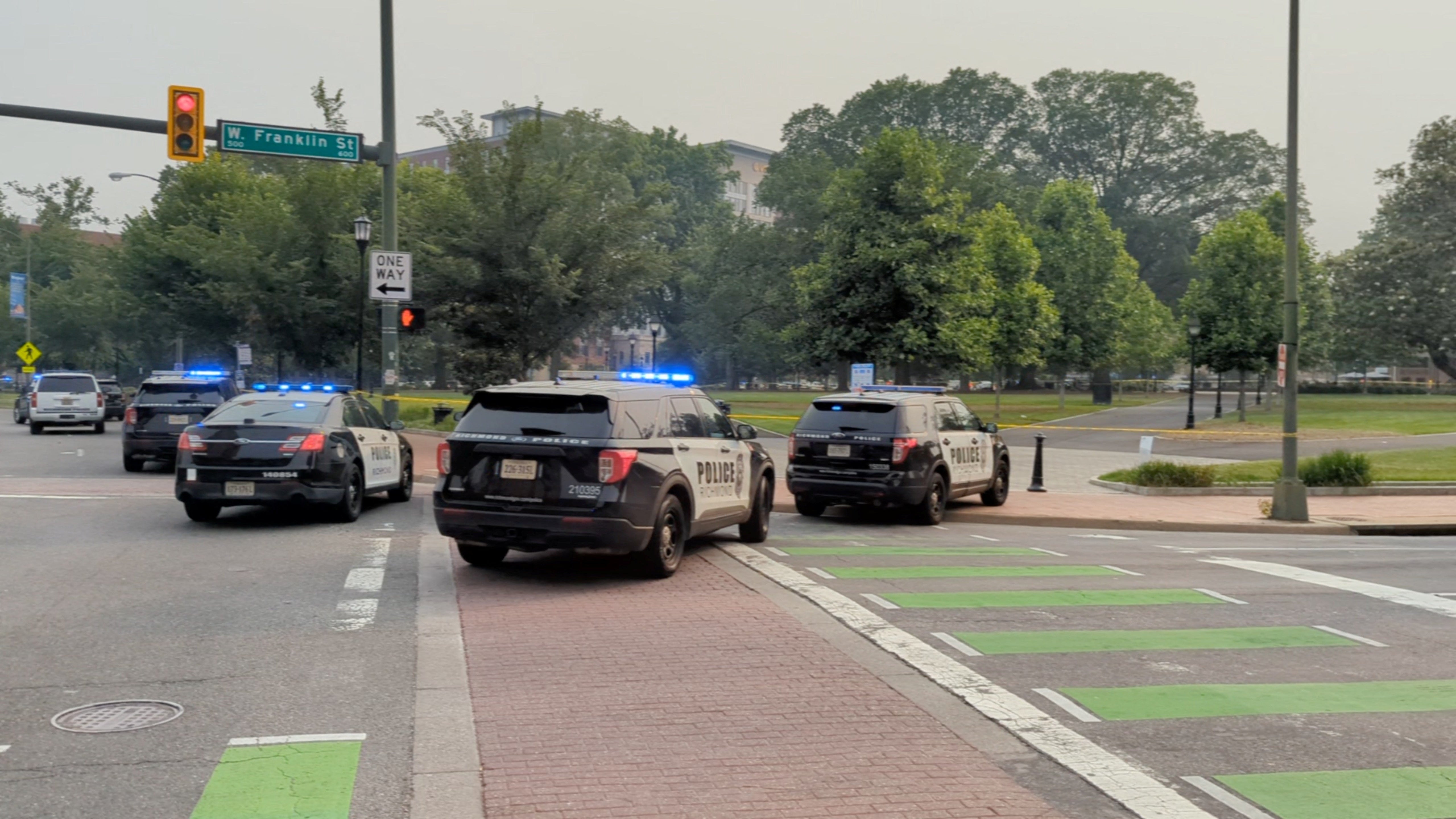 Police vehicles are seen parked near a park where, according to the police, a gunman opened fire, in Richmond, Virginia