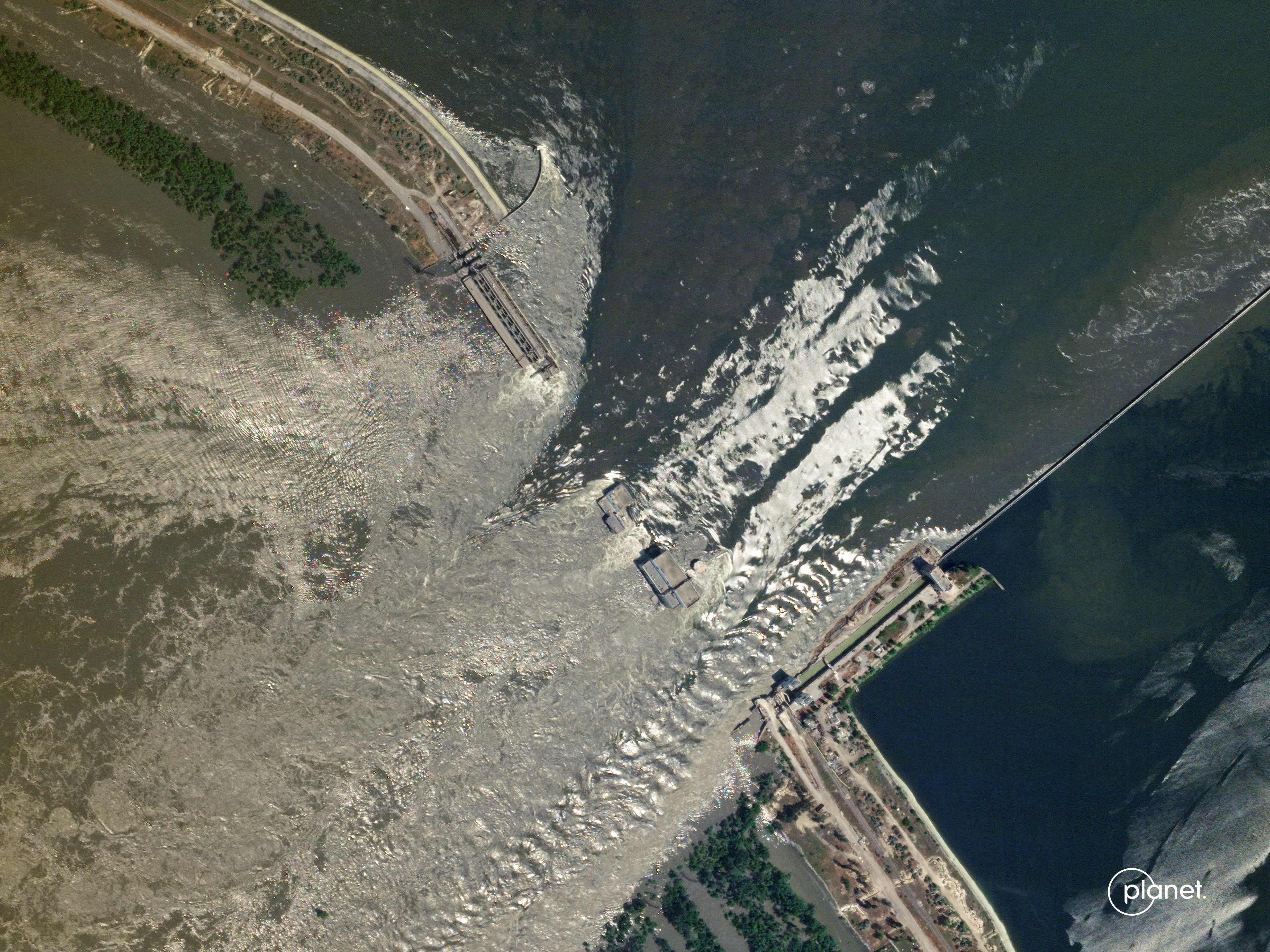 This handout SkySat image taken and released by Planet Labs PBC on June 6, 2023 shows water flowing through the damaged Kakhovka HPP dam in southern Ukraine