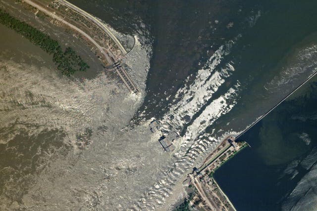 <p>This handout SkySat image taken and released by Planet Labs PBC on June 6, 2023 shows water flowing through the damaged Kakhovka HPP dam in southern Ukraine</p>
