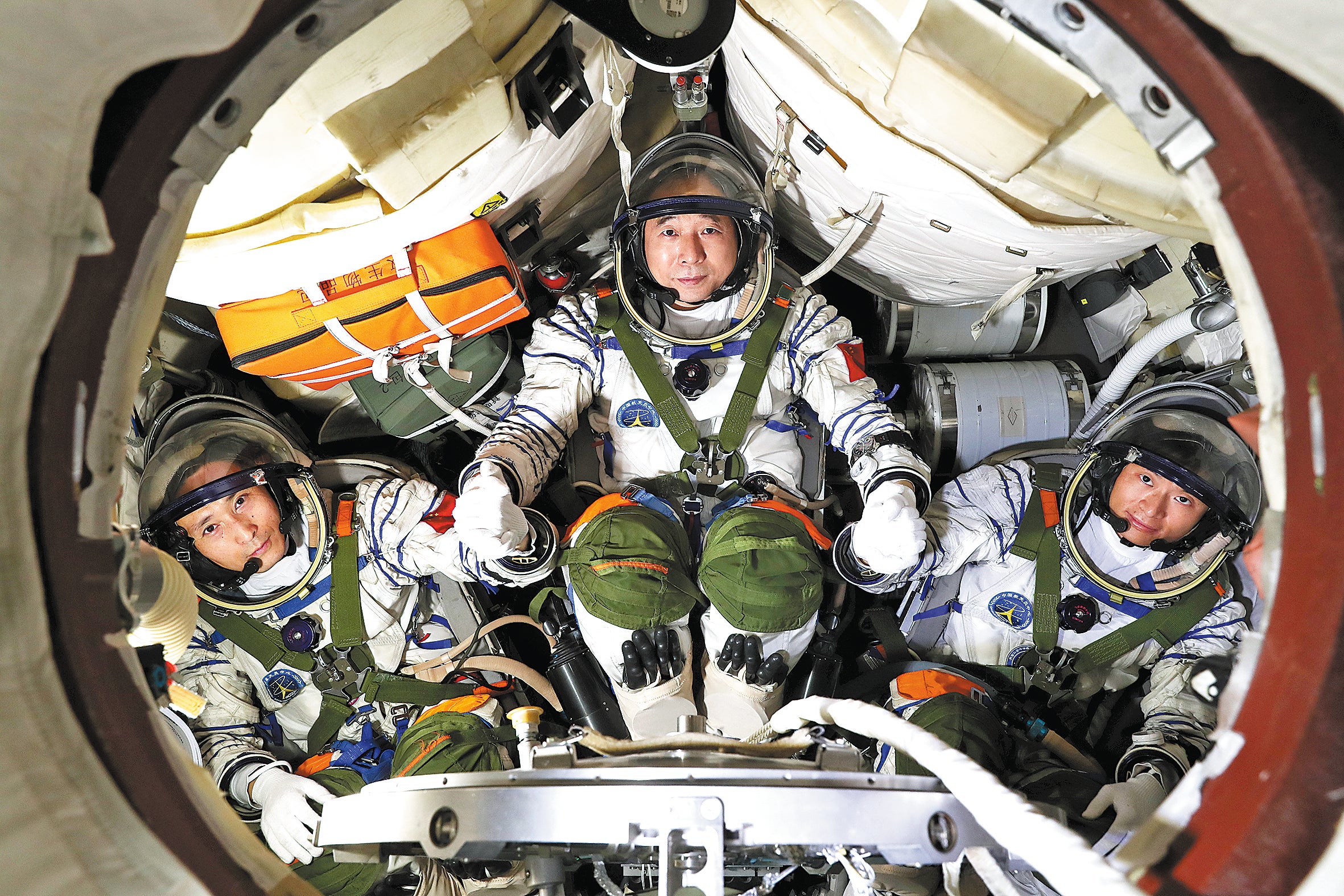 Shenzhou XVI crew members Jing Haipeng, centre, Zhu Yangzhu, left, and Gui Haichao receive training in a spaceflight simulator