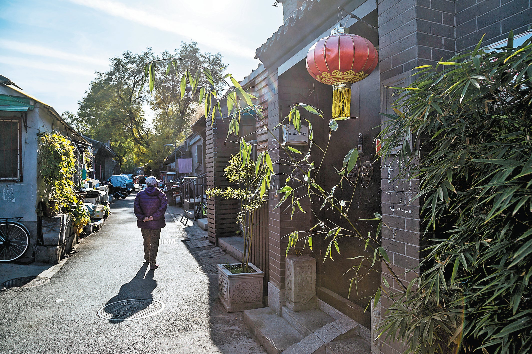 A pedestrian strolls through a hutong in Beijing
