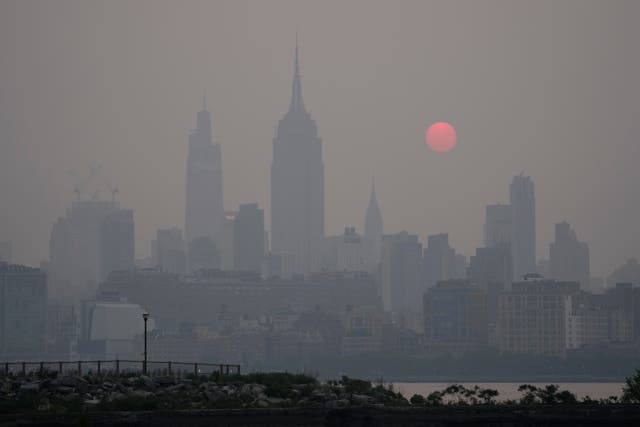 <p>The sun rises over a hazy New York City skyline as seen from Jersey City, N.J., Wednesday, June 7, 2023</p>