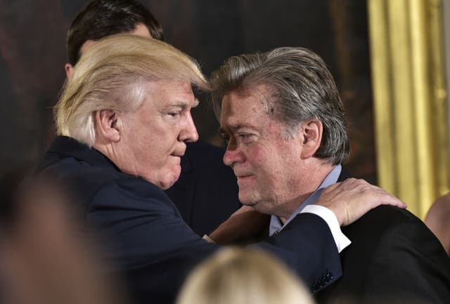<p>Donald Trump (L) congratulates Senior Counselor to the President Stephen Bannon during the swearing-in of senior staff in the East Room of the White House on January 22, 2017 in Washington, DC. </p>