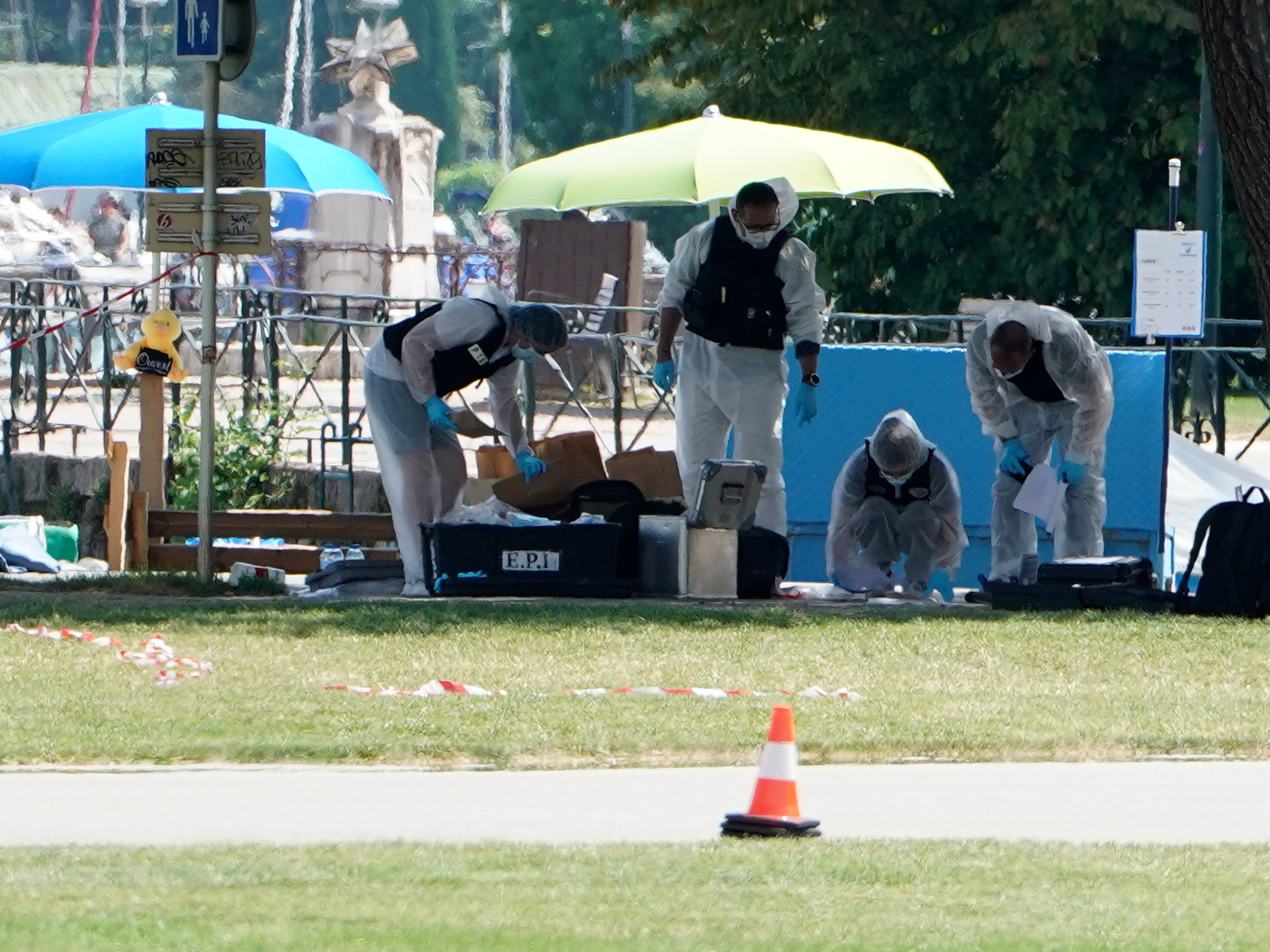 Forensics officers investigate at the scene