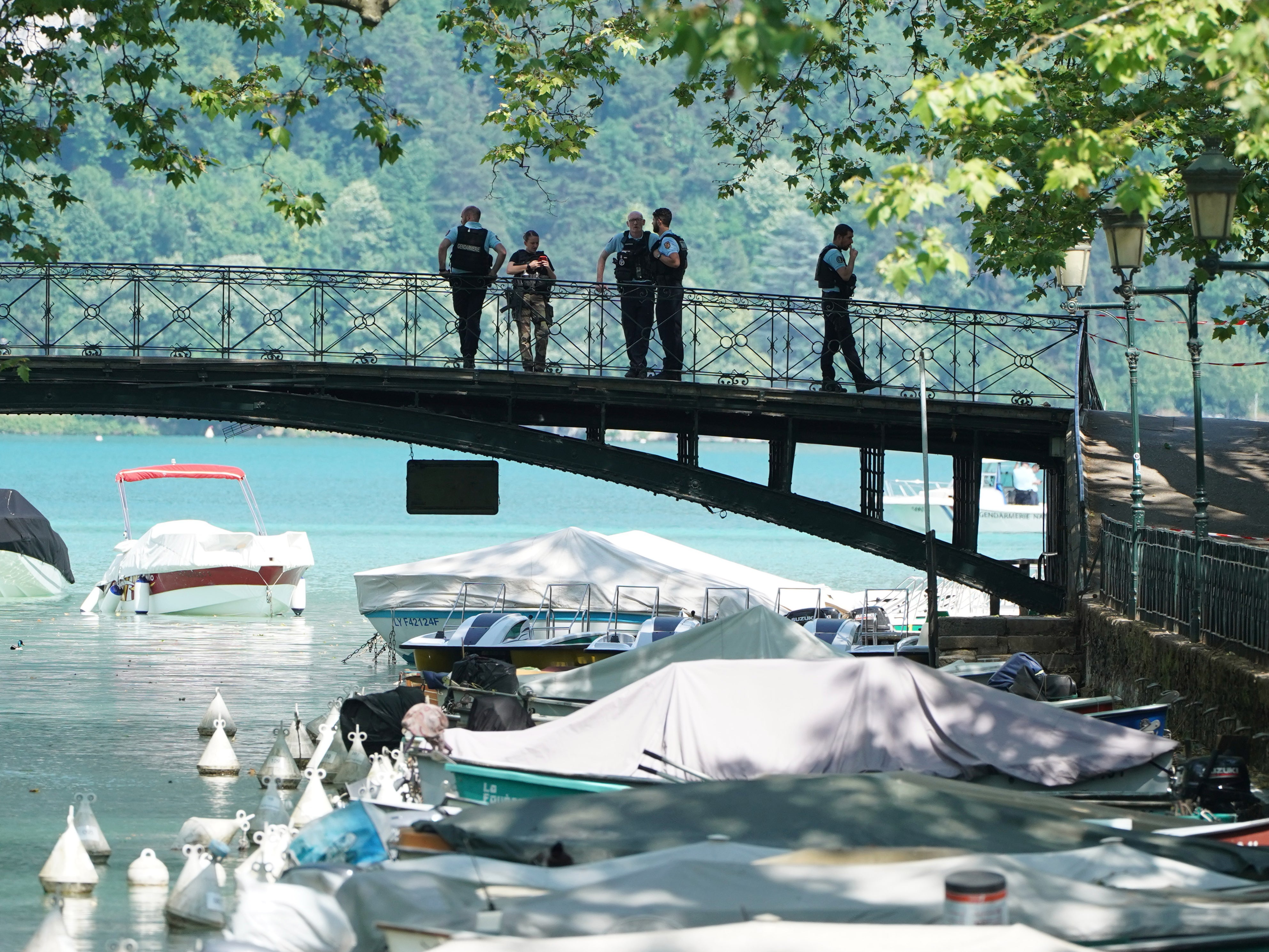 Police on a bridge near the scene in Annecy
