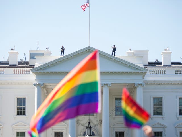 <p>Demonstrators carry rainbow flags past the White House during the Equality March for Unity and Peace on June 11, 2017 in Washington, D.C</p>