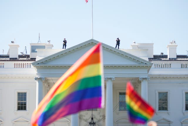 <p>Demonstrators carry rainbow flags past the White House during the Equality March for Unity and Peace on June 11, 2017 in Washington, D.C</p>