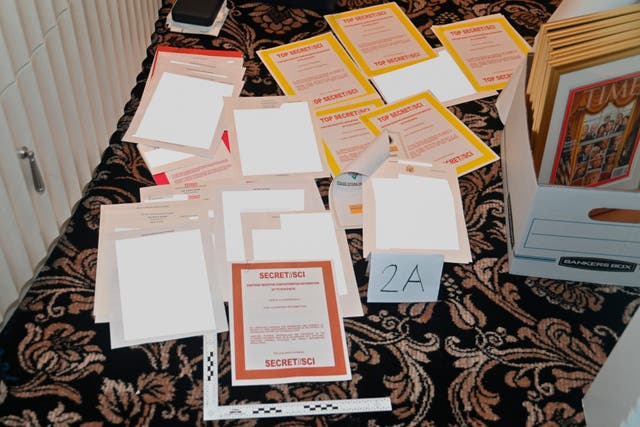 This image contained in a court filing by the Department of Justice on Aug. 30, 2022, and partially redacted by the source, shows a photo of documents seized during the Aug. 8, 2022, FBI search of former President Donald Trump's Mar-a-Lago estate.