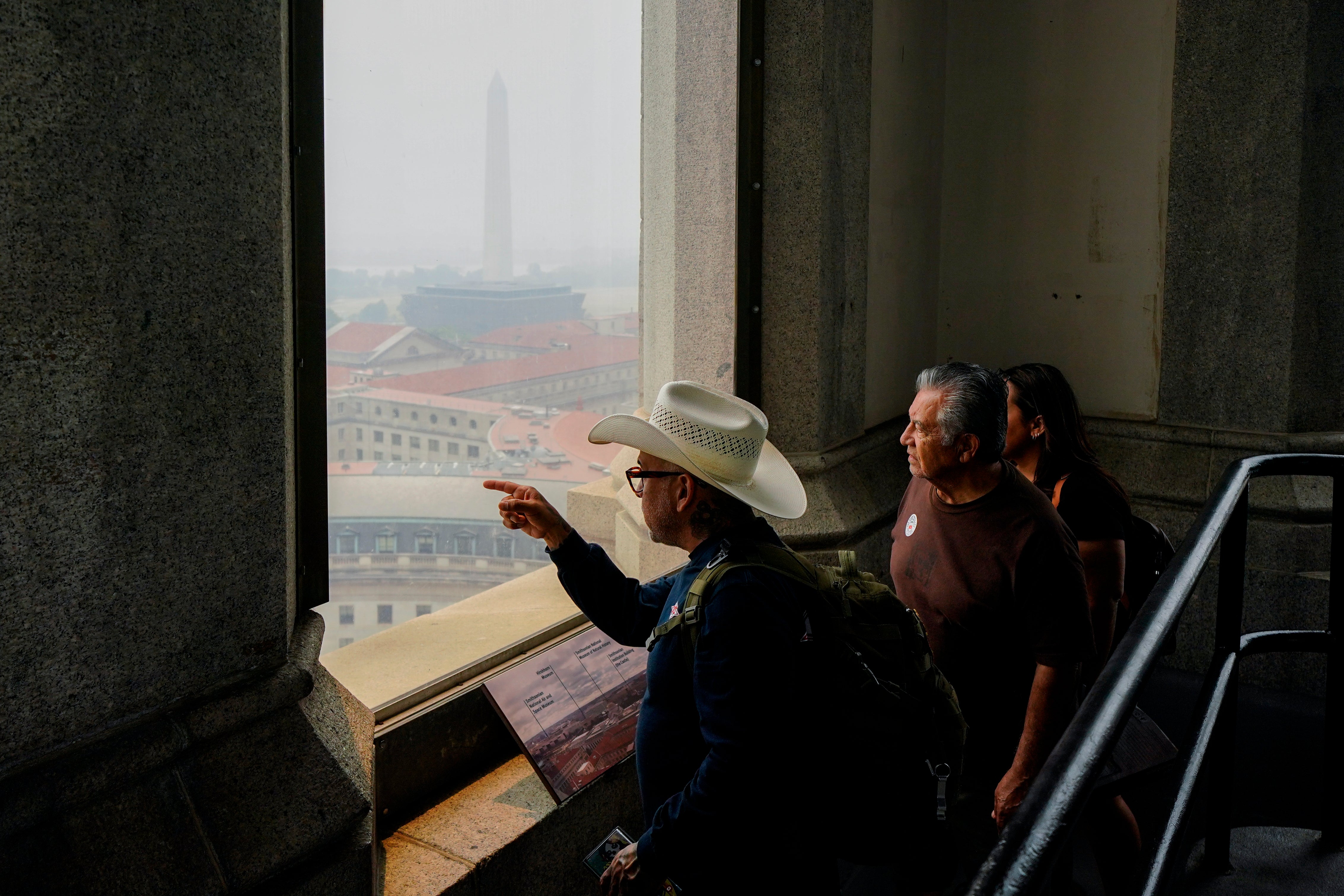 People tour the top of the Old Post Office Tower as haze from a blanket of smoke covers the view on Thursday in Washington DC