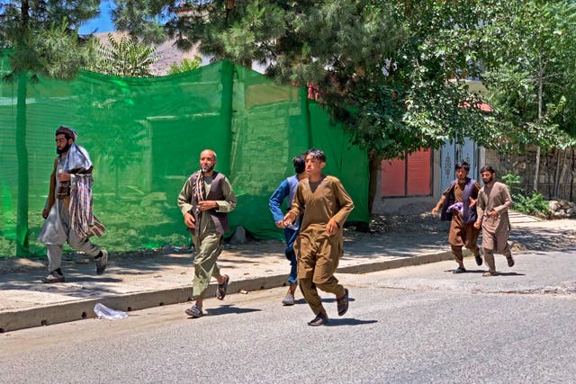 <p>People run away after a bomb explosion during Fatiha prayers at the Nabawi mosque in the Hesa-e-Awal area of Fayzabad district, Badakhshan province</p>