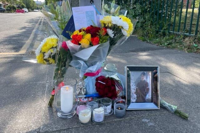 Tributes, including a picture left near the scene at Langworthy Road in Salford (Richard McCarthy/PA)