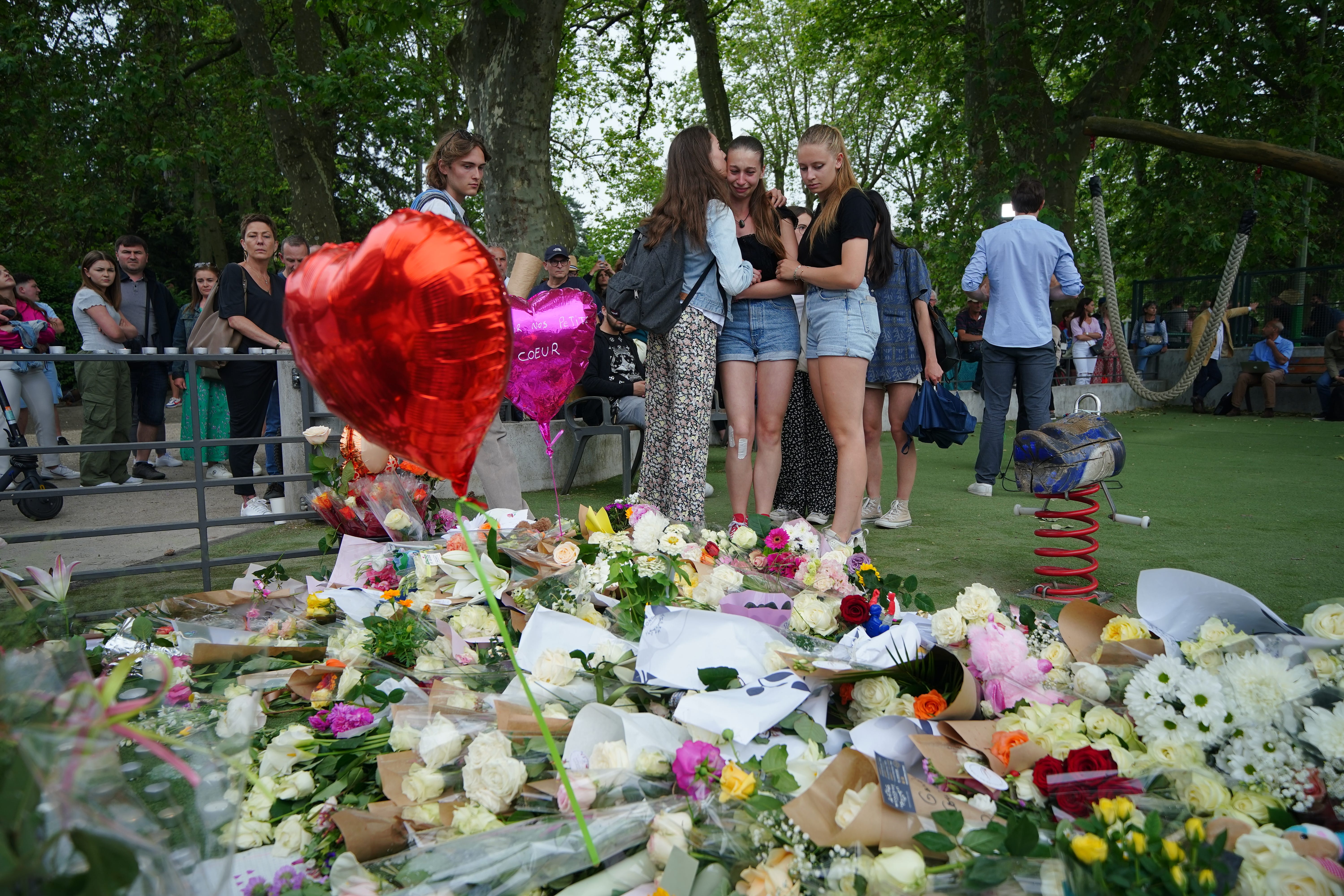 Tributes left near the scene at a lakeside park in Annecy, France, following a knife attack