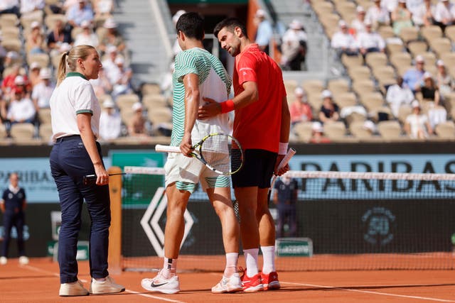 Carlos Alcaraz was beaten in four sets by Novak Djokovic, right (Jean-Francois Badias/AP)