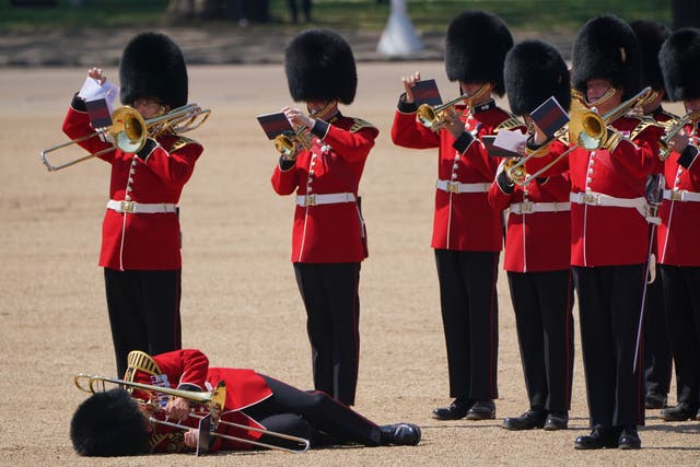 A trombone player in the military band faints during the Colonel’s Review, for Trooping the Colour, at Horse Guards Parade in London (Jonathan Brady/PA)