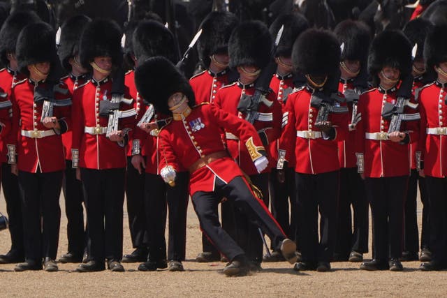 A member of the military fainting due to the heat during the Colonel’s Review (Jonathan Brady/PA)