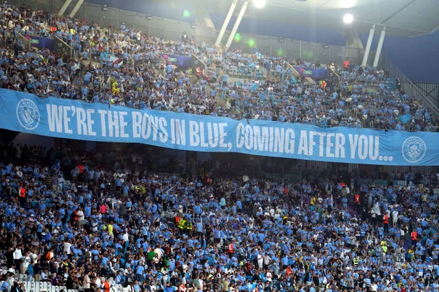 The Manchester City fans in the stands (Martin Rickett/PA)
