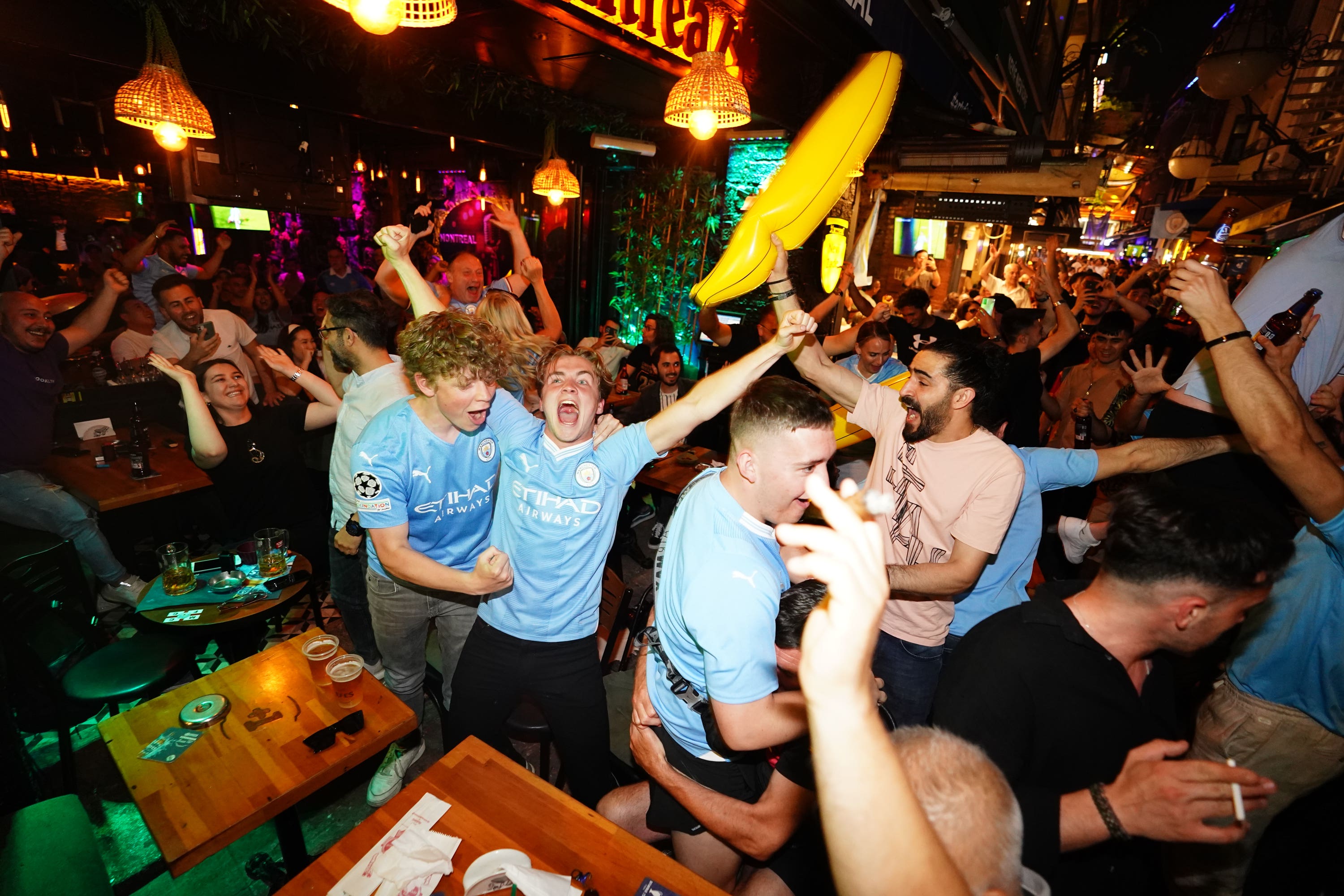 Man City fans celebrate their first goal (PA)