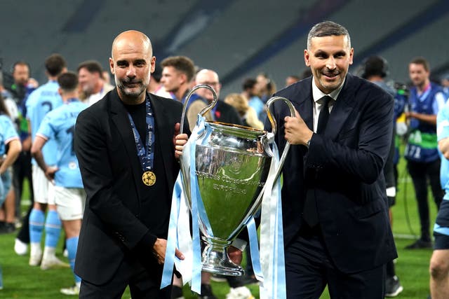 Pep Guardiola holds the Champions League trophy with Man City chairman Khaldoon Khalifa Al Mubarak (Martin Rickett/PA)