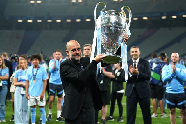 Pep Guardiola lifts the Champions League trophy (Martin Rickett/PA)