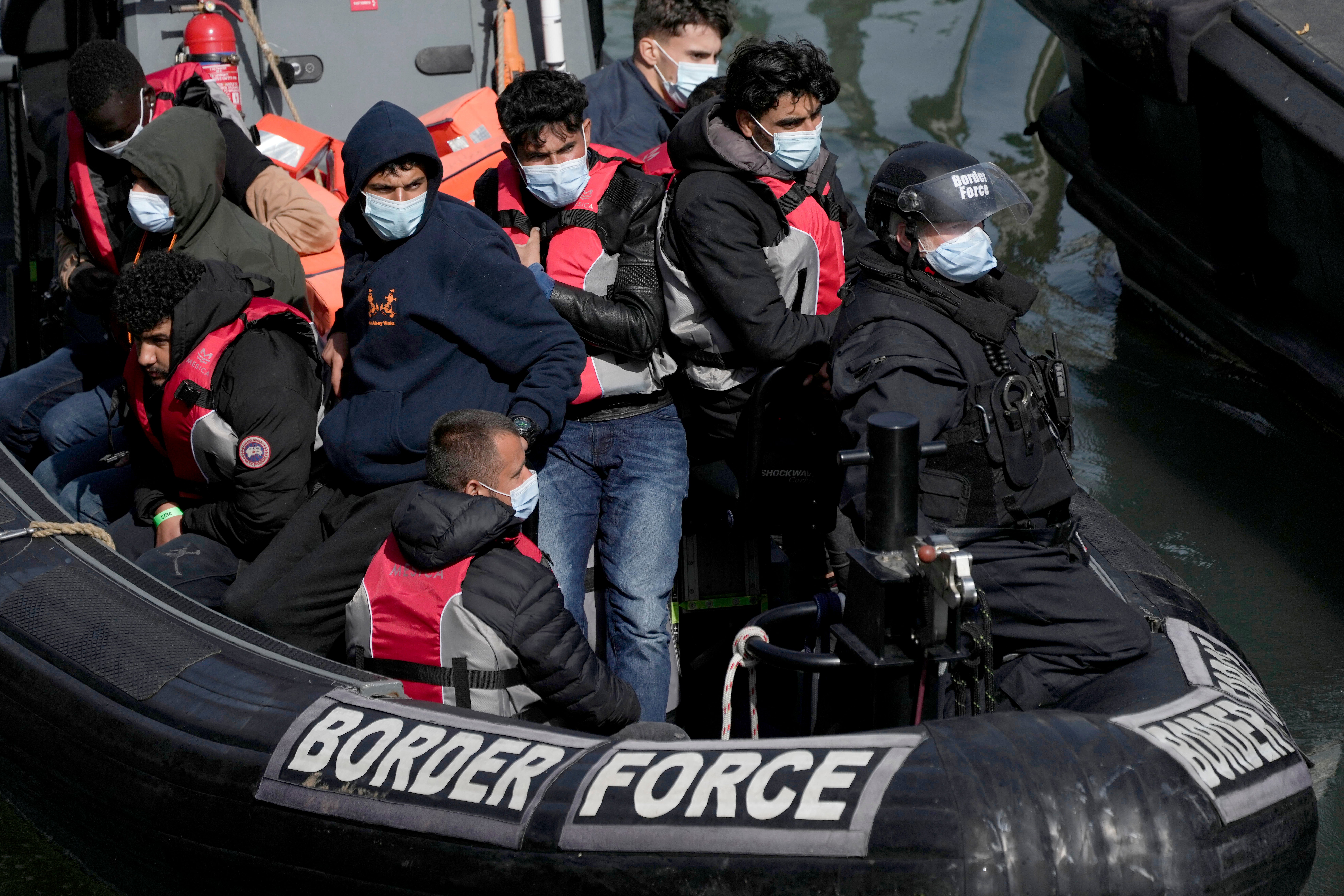 Intercepted migrants are brought to shore in Dover