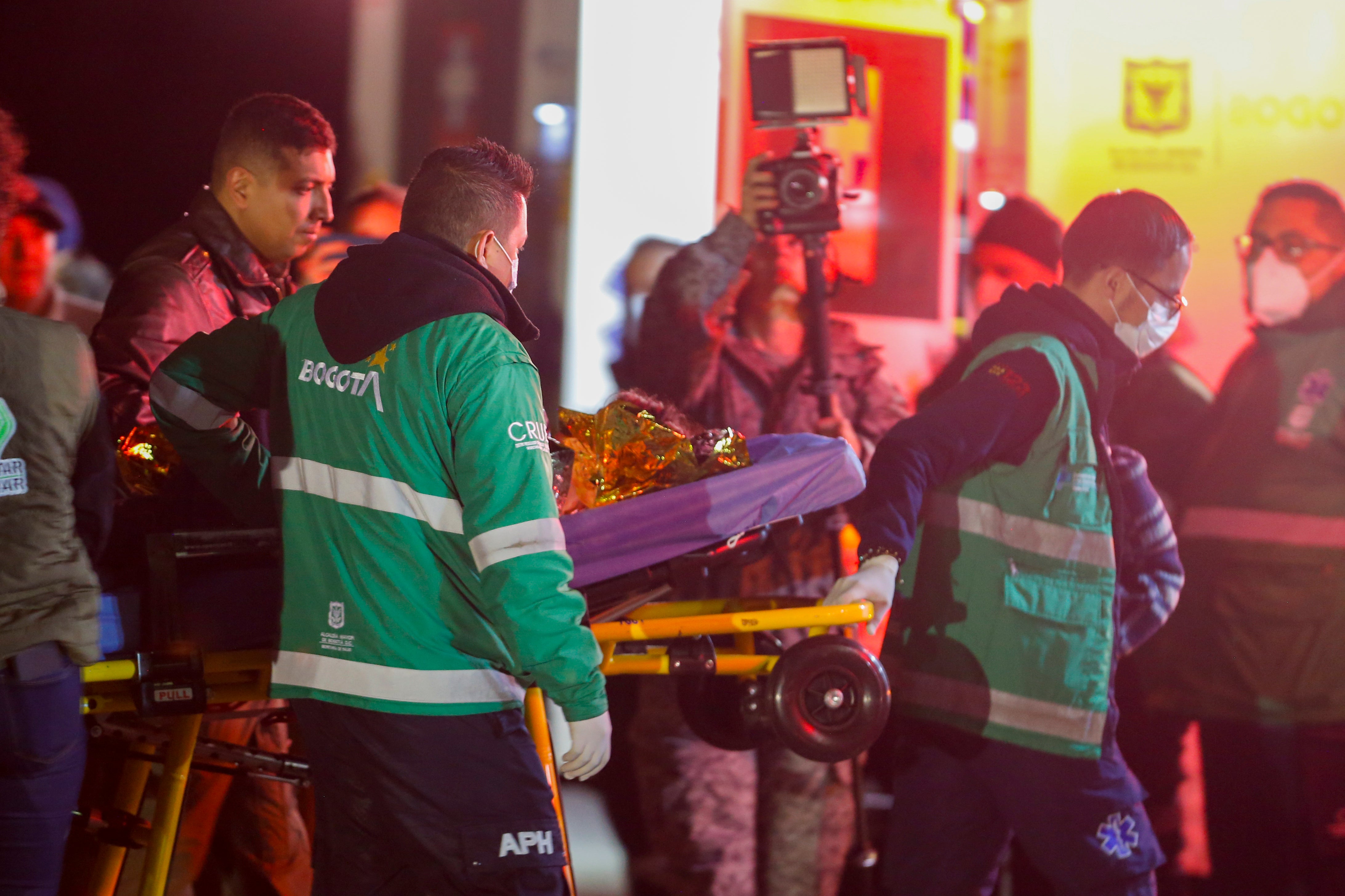 <p>Paramedics carry to an ambulance one of four Indigenous children who were missing after a deadly plane crash at the military air base in Bogota, Colombia, Saturday, June 10, 2023</p>