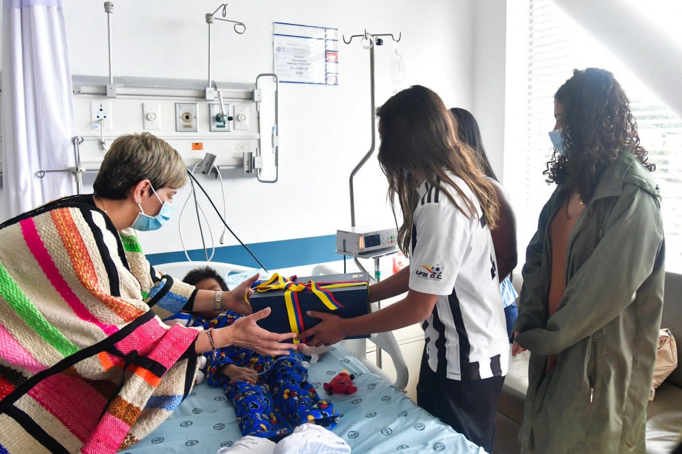 <p>Colombia's First Lady Veronica Alcocer (L) and Sofia Petro (R), daughter of Colombian President Gustavo Petro, visiting one of the four Indigenous children </p>