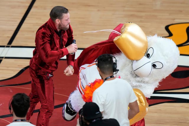 <p>Conor McGregor striking ‘Burnie’, the Miami Heat mascot (Lynne Sladky/AP)</p>