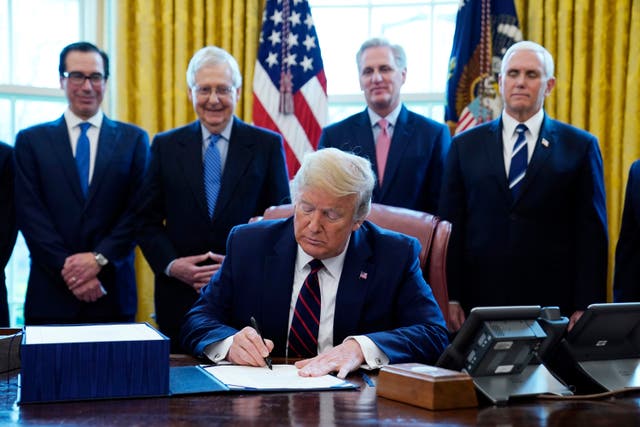 <p>President Donald Trump signs the coronavirus stimulus relief package, at the White House</p>