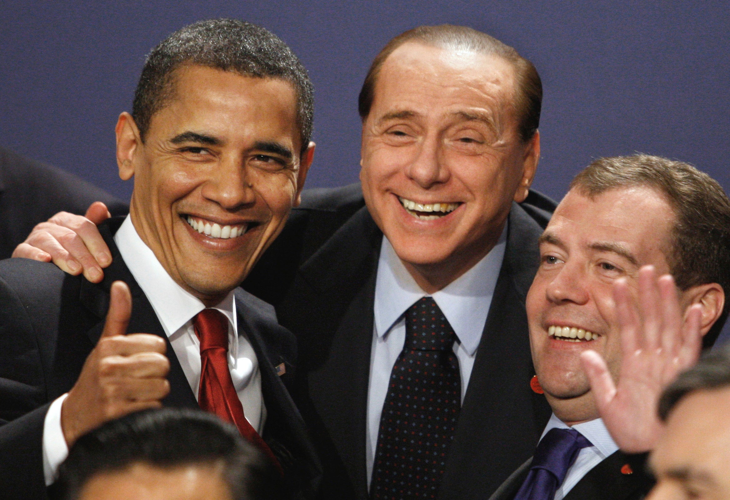 Barack Obama, Berlusconi and Russian president Dmitry Medvedev smile in a group photo at the G20 summit in London