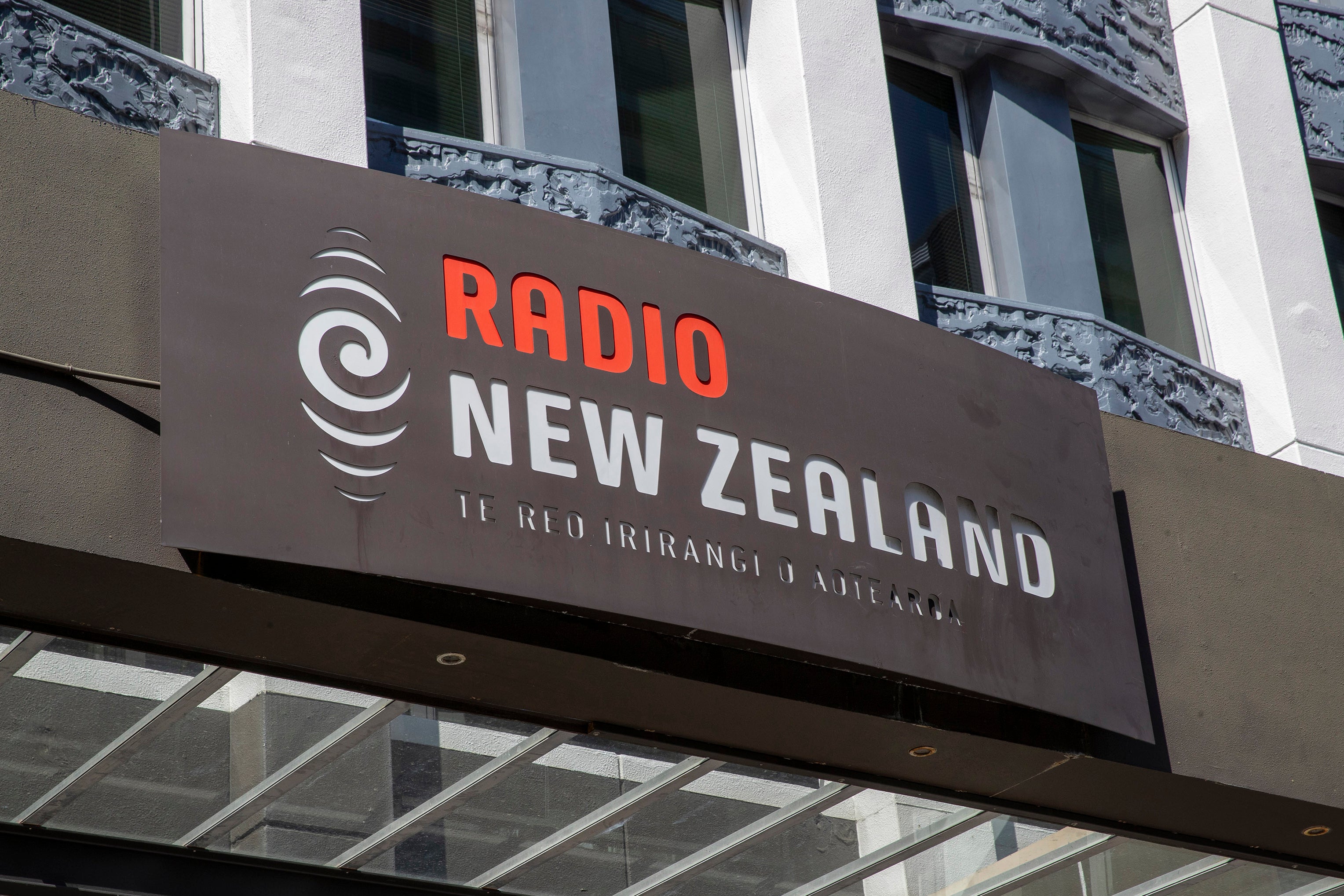 Signage is displayed on the Radio New Zealand building in Wellington, New Zealand