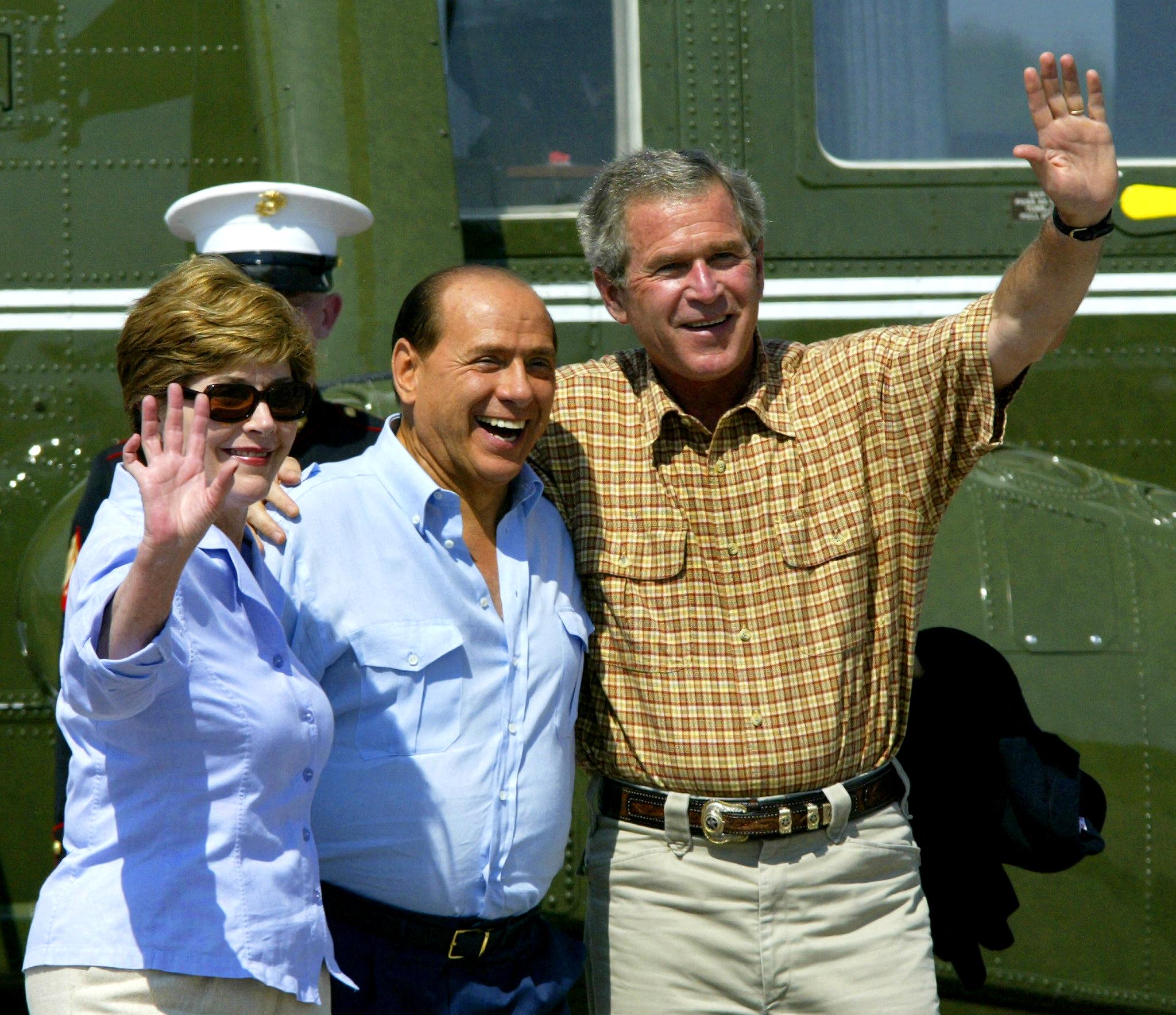 The former Italian prime minister with George W Bush, right, and first lady Laura Bush, on his arrival at Bush’s Prairie Chapel Ranch in Texas in 2003