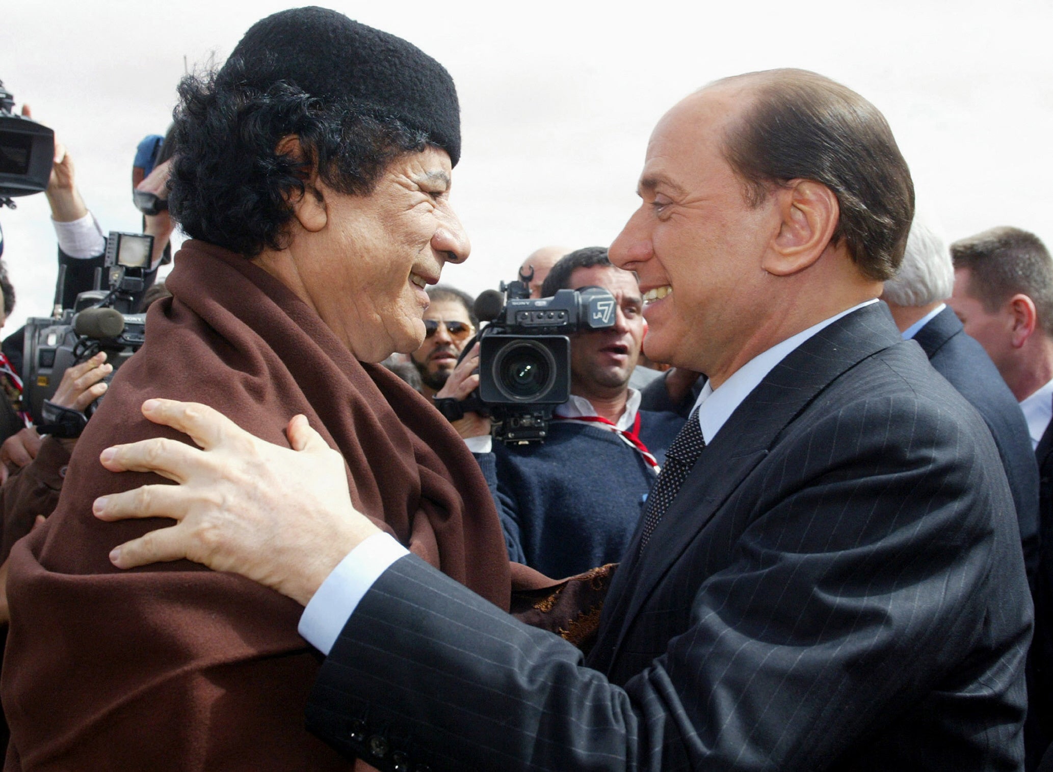 Libyan leader Muammar Gaddafi, left, greets Berlusconi during a meeting in Sirte on 10 February 2004