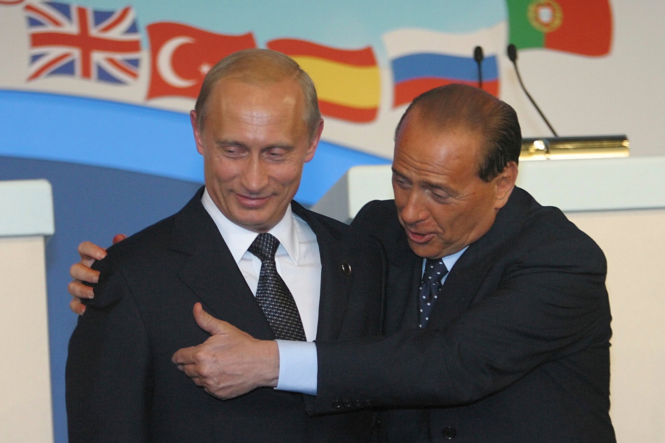 <p>Vladimir Putin and Silvio Berlusconi at a Nato-Russia summit in 2002</p>
