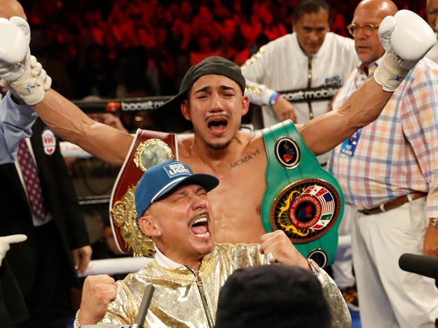 <p>Teofimo Lopez Jr (centre) celebrates with his father (front) in August 2022</p>