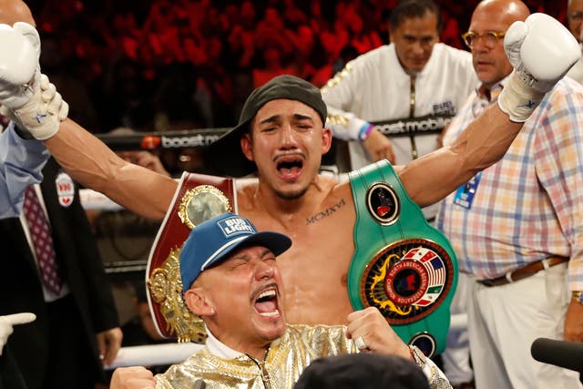 <p>Teofimo Lopez Jr (centre) celebrates with his father (front) in August 2022</p>