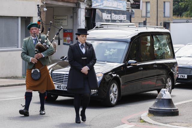 The hearse carrying the coffin of Hugh Callaghan arrives for his funeral (Belinda Jiao/PA)