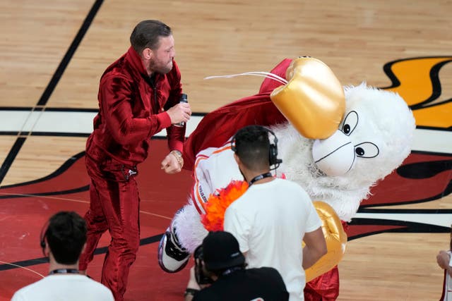 <p>Former MMA fighter Conor McGregor punches Burnie, the Miami Heat mascot, during a break in Game 4 of the basketball NBA Finals against the Denver Nuggets, Friday, June 9, 2023, in Miami.</p>