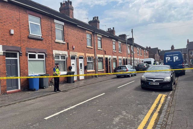 A police community support officer at the scene on Flax Street, Stoke-on-Trent, Staffordshire, where the victims of a suspected double murder on Sunday were a seven-year-old girl and an 11-year-old boy, police have said. Picture date: Monday June 12, 2023.