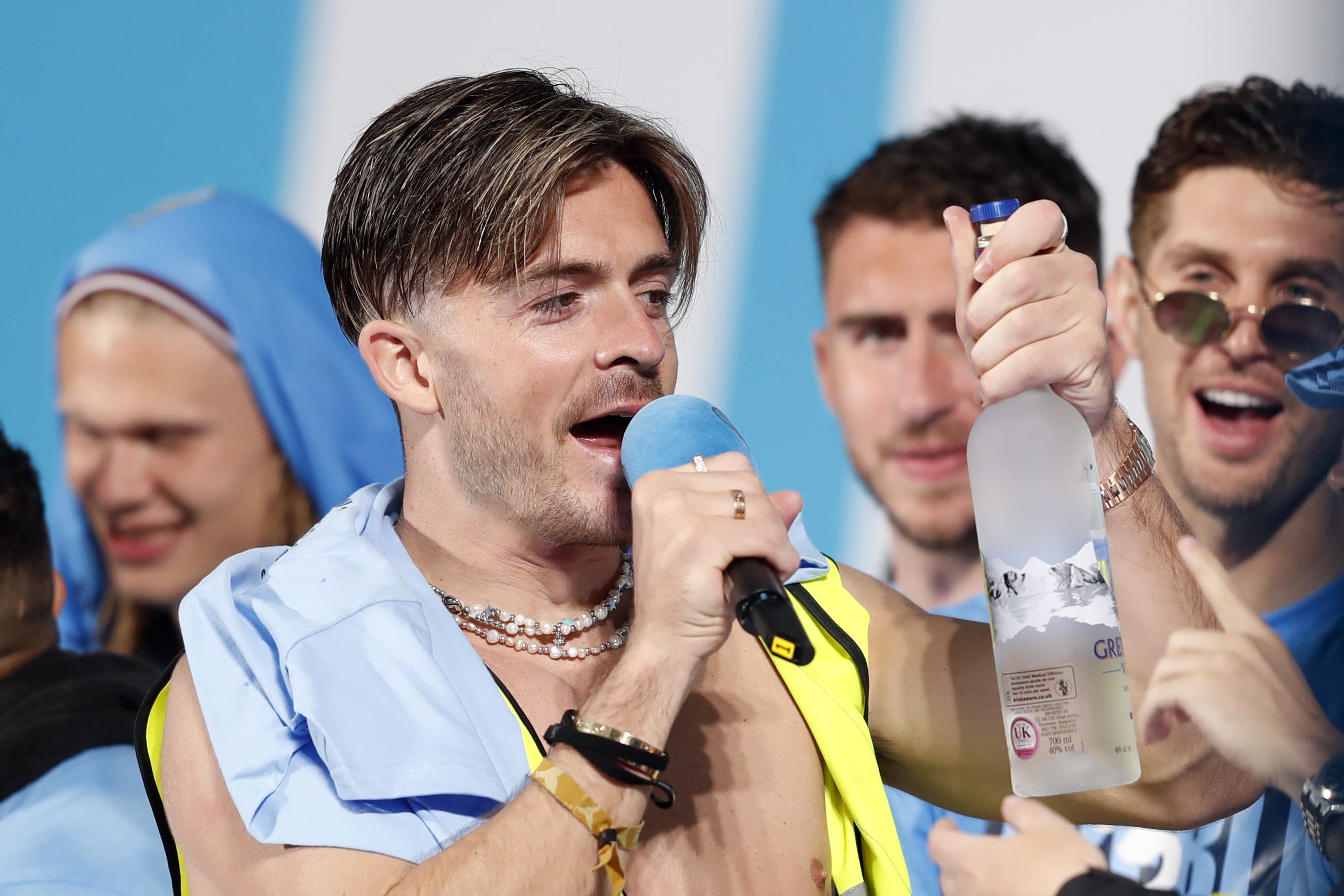 Manchester City’s Jack Grealish with a bottle of vodka on stage (Will Matthews/PA)