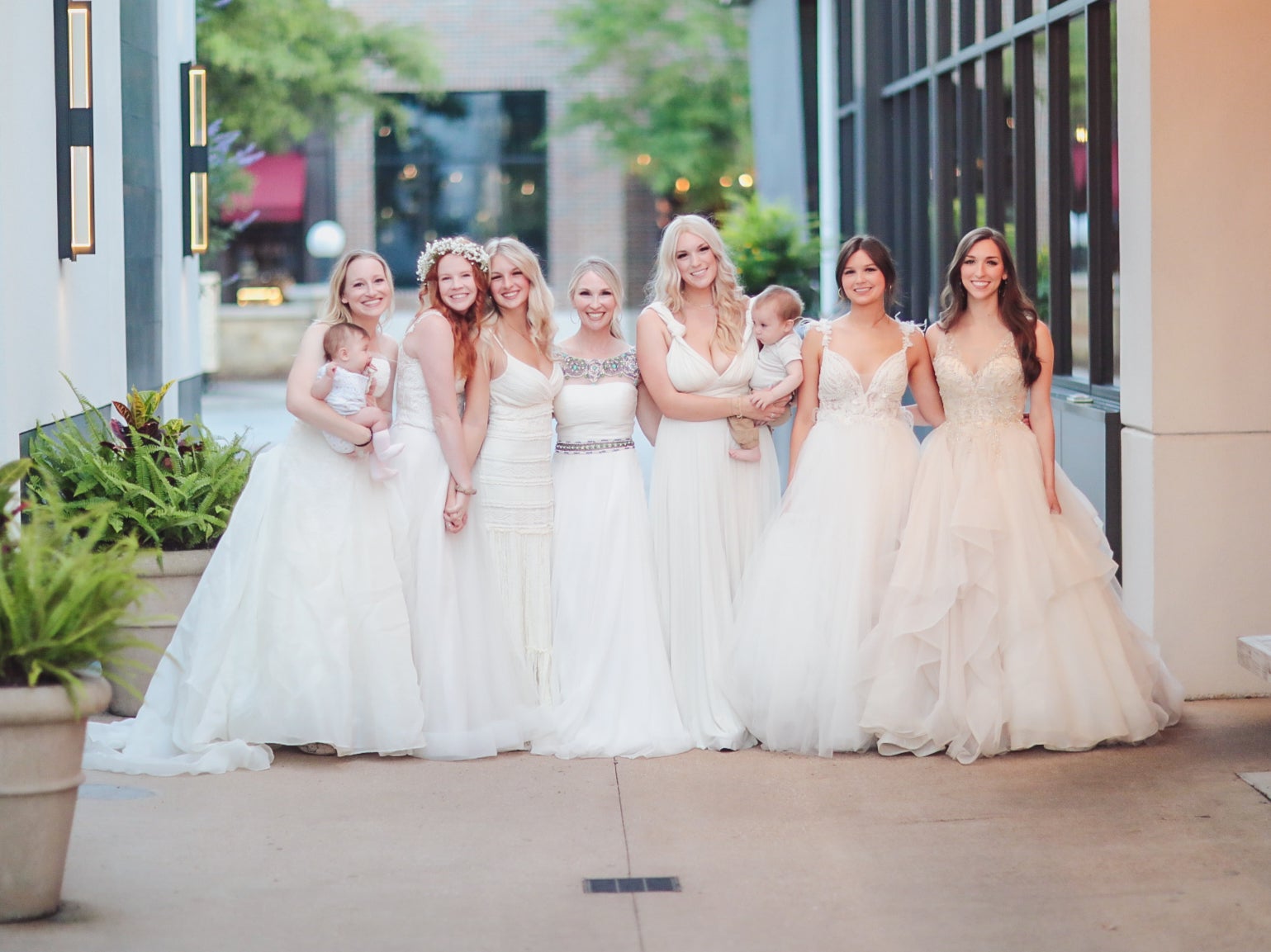 Mother and six daughters wear their wedding dresses out to dinner