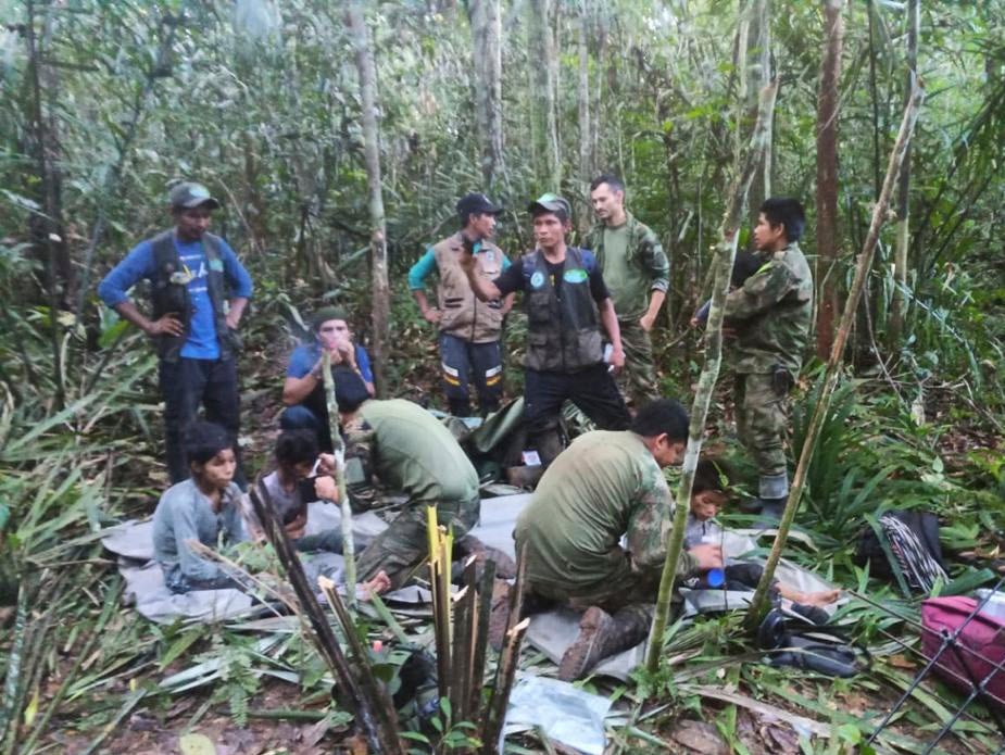 In this photo released by Colombia’s Armed Forces Press Office, soldiers and Indigenous tend to the four children