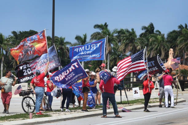 <p>Supporters of former president Donald Trump gather near his Mar-A-Lago home after he was indicted on a new set of charges related to the mishandling of classified documents on 11 June 2023 in Palm Beach, Florida</p>