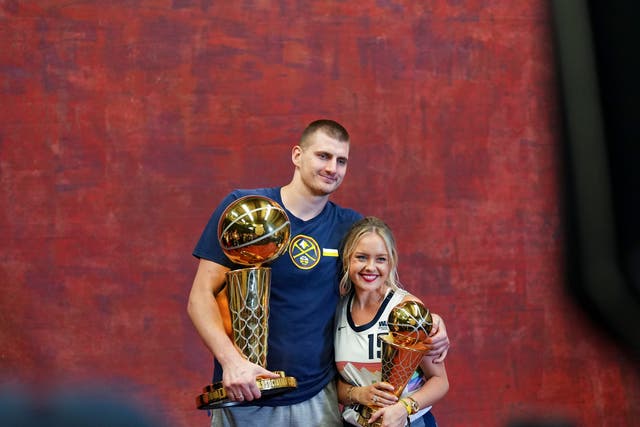 <p>Denver Nuggets centre Nikola Jokic and his wife Natalija with the Larry O’Brien NBA Championship Trophy and MVP award</p>
